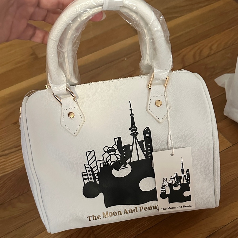 White Dome Satchel Handbag.
The moon and penny brand